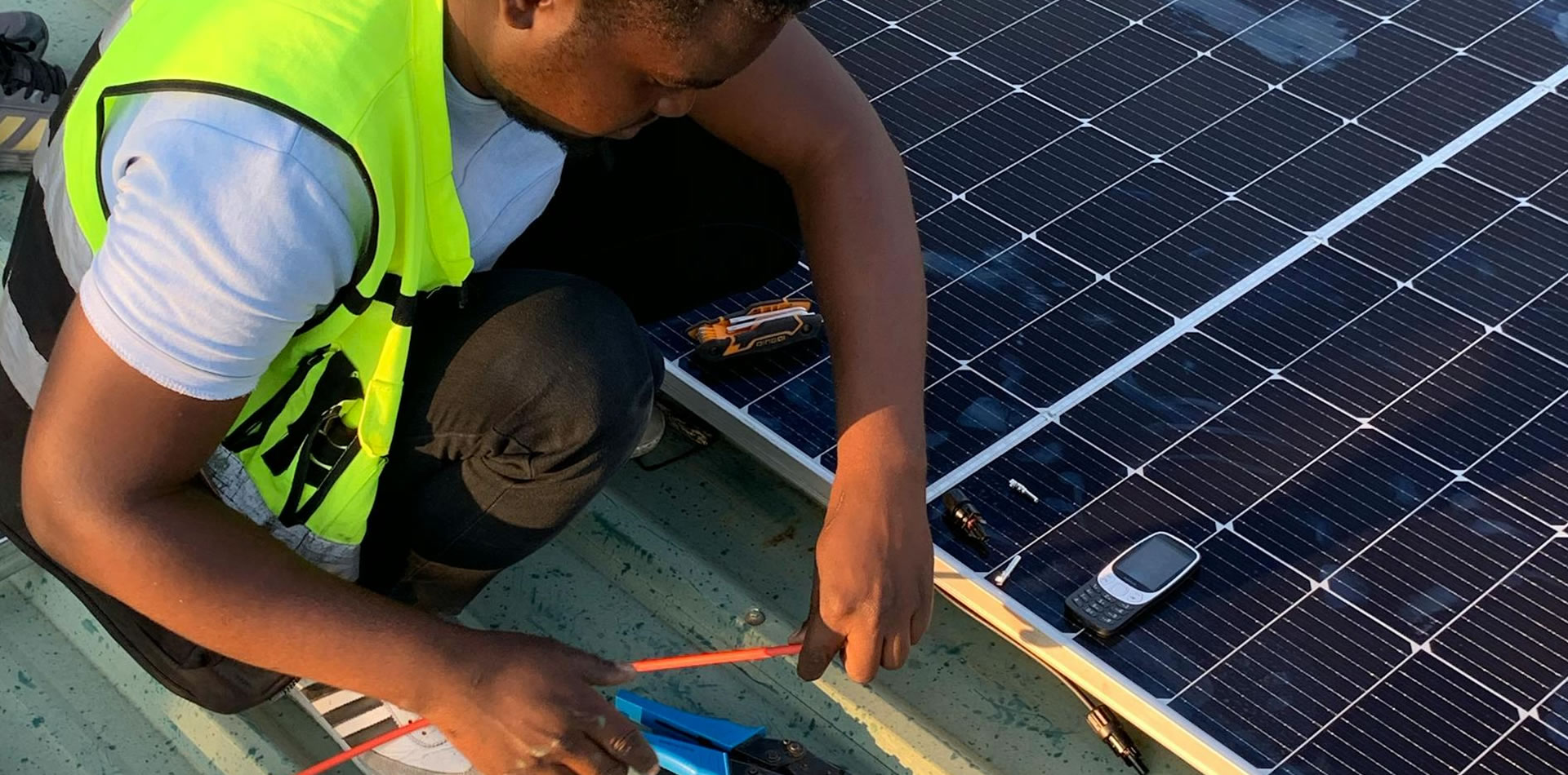 Electrical power installations, engineers working on solar panels or power grids with E-Network